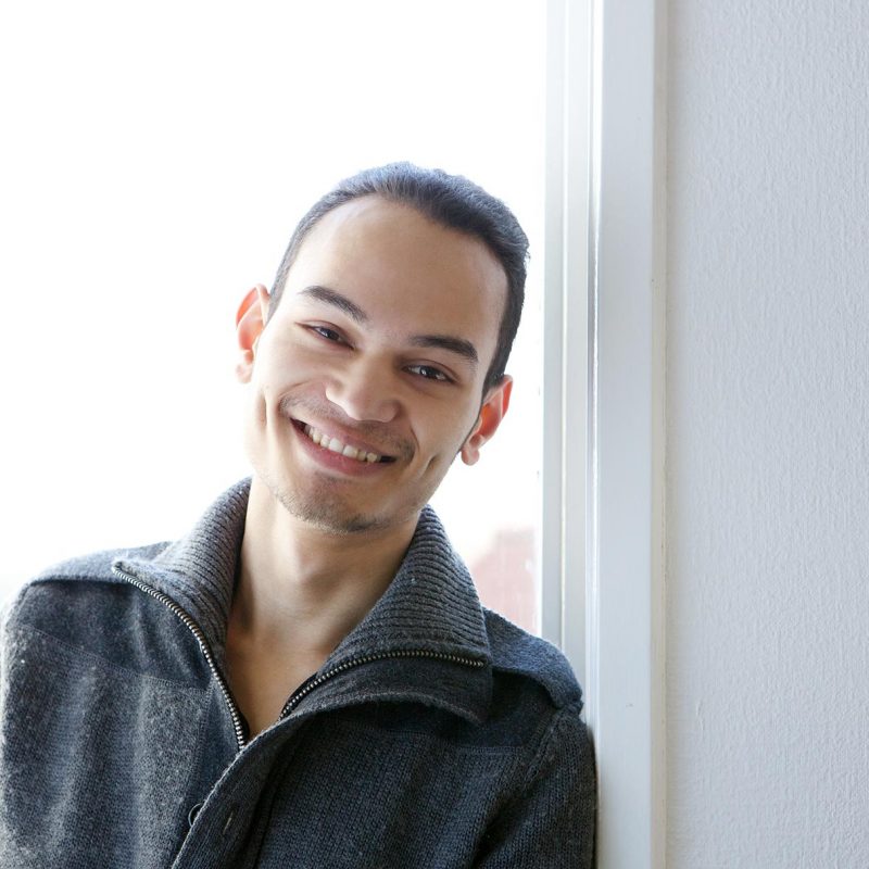young-asian-man-smiling-at-home-PBGE75L.jpg
